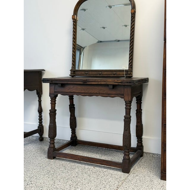 This late 19th to early 20th century Baroque Revival oak table has a fold-over top. When opened, it reveals an inset...