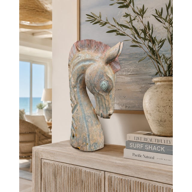 A striking monumental horse head sculpture hand carved from hardwood and finished in a beautifully weathered polychrome...