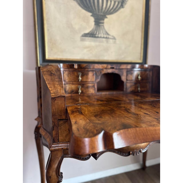 Beautiful antique burr walnut secretary desk with an elegant fall-front design and richly figured veneer throughout. The...