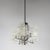 An Italian chandelier from the 1970s characterised by a geometric chrome-plated metal structure surrounded by a...