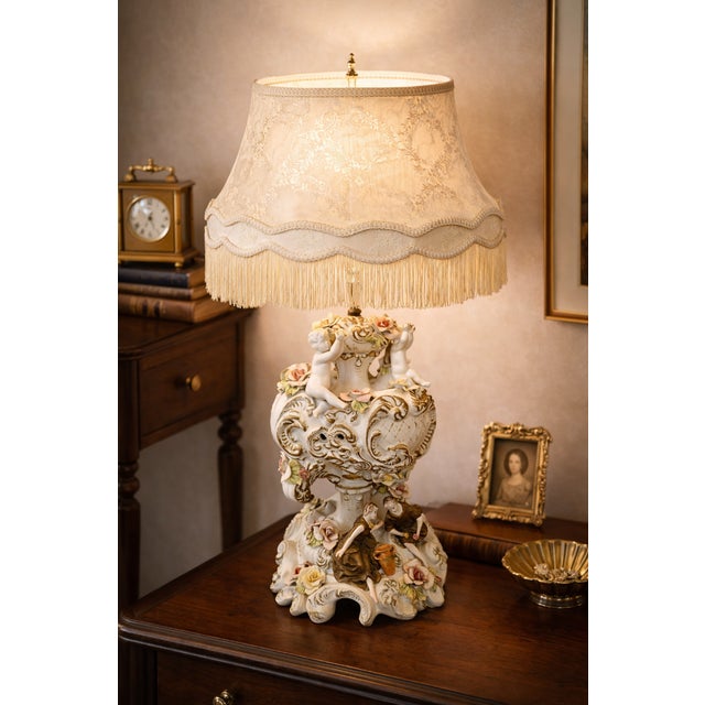 This richly sculptural Italian porcelain table lamp is a dramatic example of Capodimonte-style Rococo Revival, attributed...