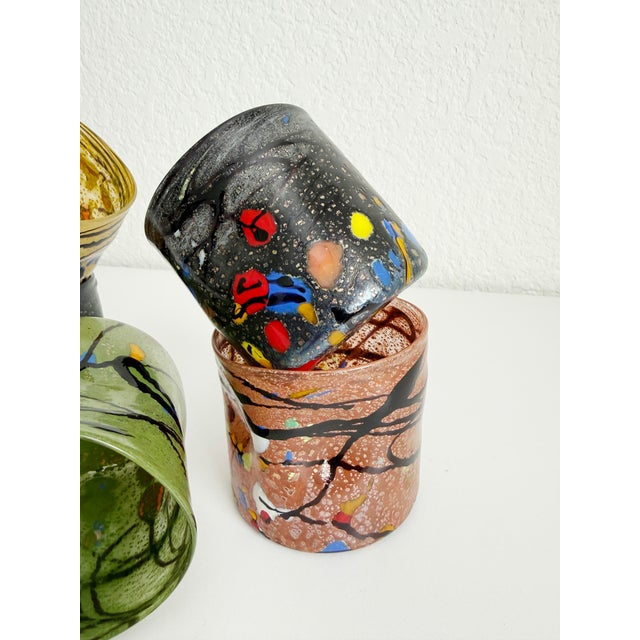 These colorful, distinctive blown Murano-attributed glass tumblers feature a Goto or Gotto pattern, which is an abstract,...