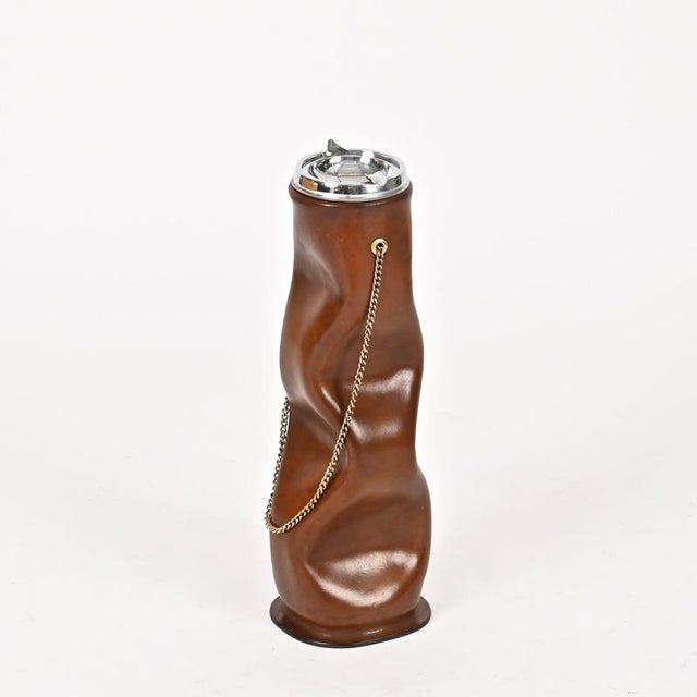 Stunning floor-standing ashtray fully made from thick Italian sculpted leather, chromed metal, and completed with a...