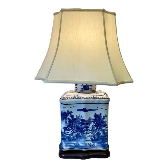 Blue and White Porcelain Tea Jar Table Lamp Decorated With an Asian Landscape Scene Resting on a Wooden Base With Cream Colored Lampshade For Sale