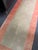 Design Plus Gallery presents a 2ft 5in x 7ft 10in Tibetan runner. The rug displays a muted sage green field surrounded by...
