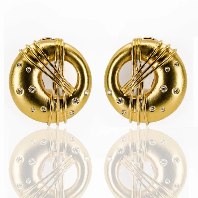 18k Yellow Gold Abstract style earrings with 18 round brilliant diamonds weighing 0.21 carats. 18.45 grams