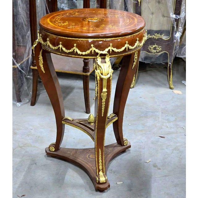 Add a touch of timeless European luxury to your home with this exquisite French Empire-inspired side table, meticulously...