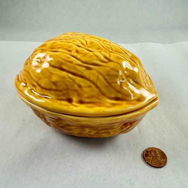 From France, attributed to Sarreguemines, an earthenware pottery covered box formed as a Walnut, circa 1940-1950. Molded...