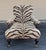 George Smith Edwardian Style Chair and Ottoman in zebra patterned chenille like fabric on turned legs with brass casters....
