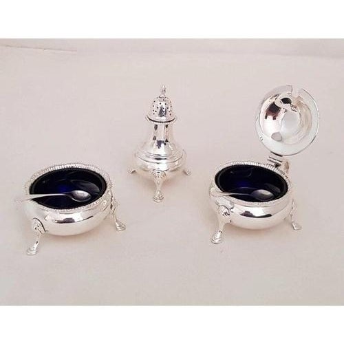 A fine english three-piece sterling silver cruet set by the celebrated london silversmiths edward barnard & sons ltd,...