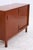 Vintage mahogany chest of drawers with two large sliding doors and a clean, linear design. The doors overlap, revealing a...