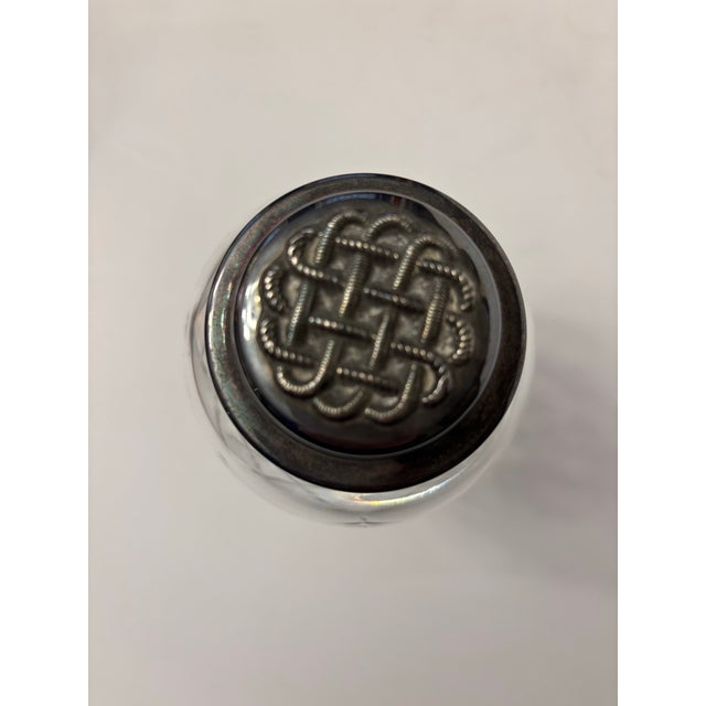 This is a mid-century modern silver-plated and cut glass cocktail shaker. It features Waterford's iconic, Gothic-inspired...