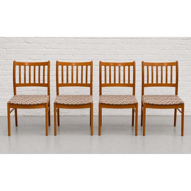 Set of four Danish Mid Century Modern dining chairs, c. 1960’s featuring warm solid teak frames with gently curved backs...