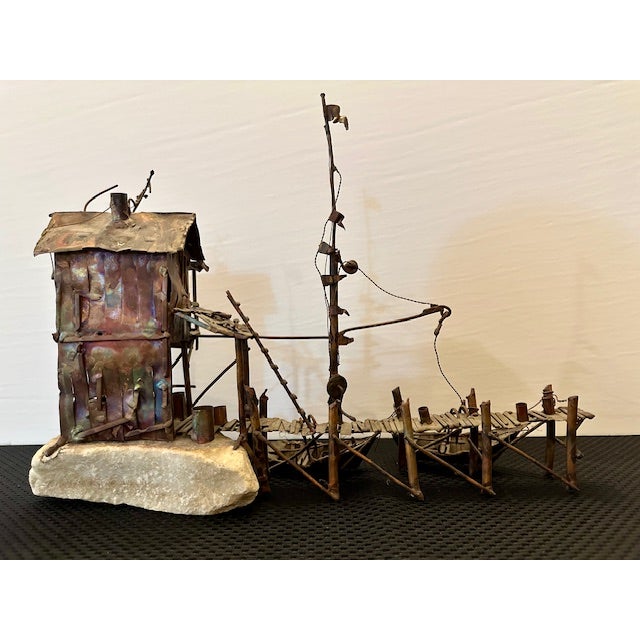 We love this sculpture’s intricate details – from the two-story bait shack replete with stilts and an antenna, to the...