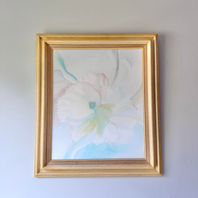 Vintage 1980s orchid oil painting on canvas board in original framing. The piece is signed by the artist Pommie Echok....