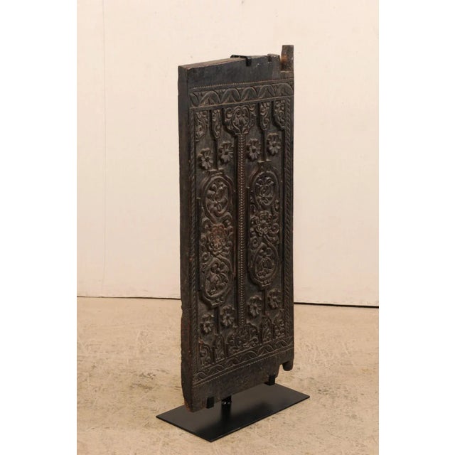 A Balinese smaller-sized carved wood barn door from the early to mid 20th century on custom iron stand. This wooden door...