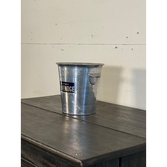 Likely originating from the 1940s–50s, these vintage champagne buckets were produced by champagne houses for promotional...