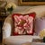 Needlepoint floral accent pillow featuring a large pink rose on a rich red background. Finished with coordinating...