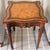 Maitland Smith Leather Top Table A scalloped shaped table with leather top. The apron is adorned with dense vertical...