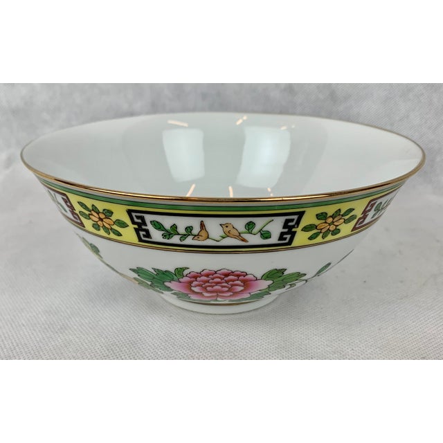 Hand decorated Chinese porcelain bowl from the 1950's. The gilt rim tops a yellow border of panels showing birds on...