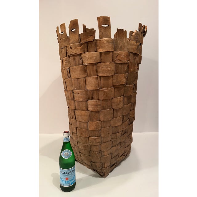 Supersized antique woven basket having thick weathered woven strips of chestnut or white oak, slightly tapered cylindrical...