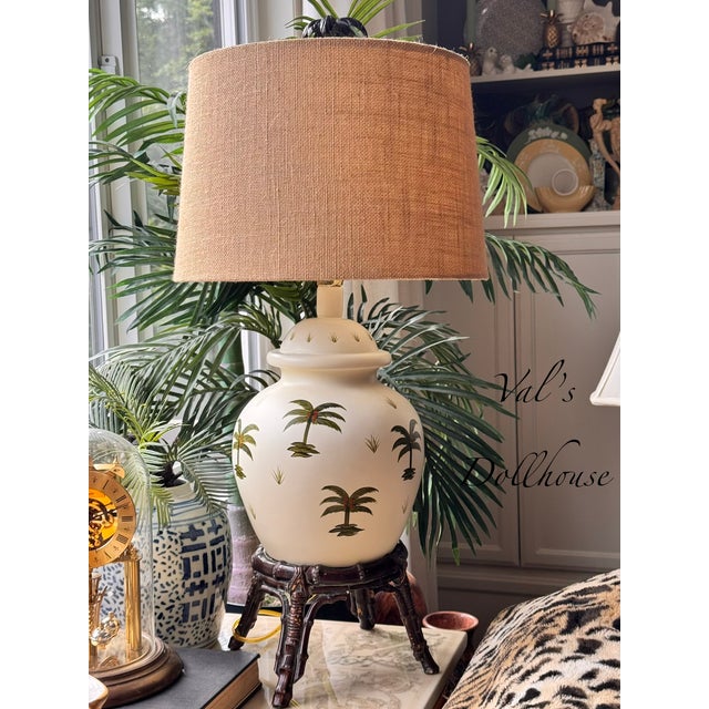 Hollywood Regency meets Chinoiserie with this ginger jar shaped lamp on attached rattan base, accented with hand painted...
