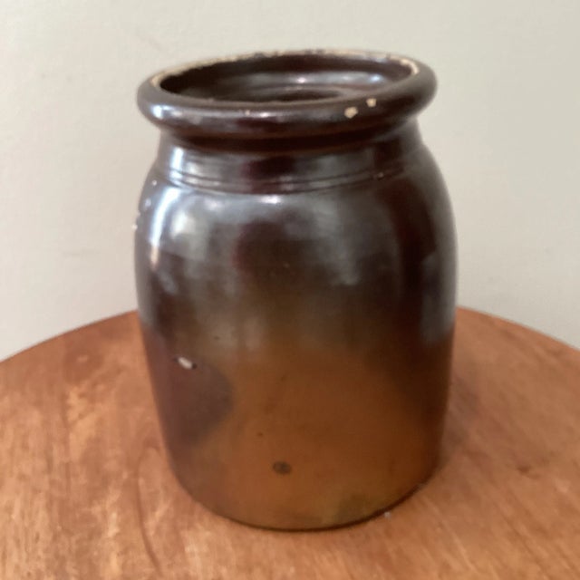 This antique brown glazed stoneware crock with carved wooden utensils hails from France and dates back to the early 20th...
