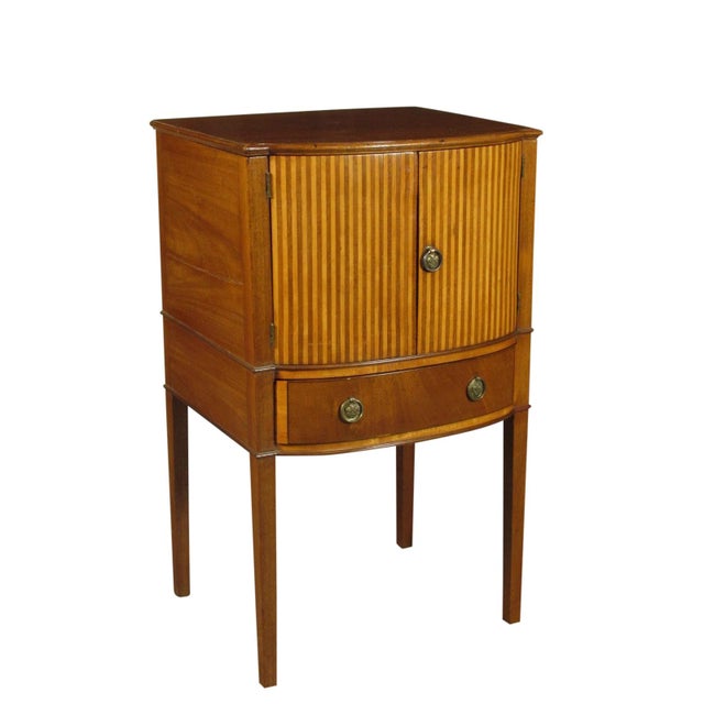 An early 19th-C. Regency inlaid mahogany nightstand with a lift-lid that opens to reveal a compartment where a porcelain...