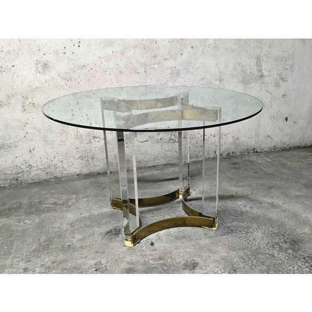 Beautiful designer table by Alessandro Albrizzi, round thick glass top, acrylic glass and brass legs, Italy, 1970. Very...