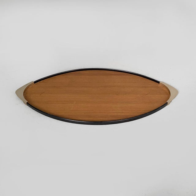 Italian mid-century modern brass and black wood tray by MB Italia, 1950s Oval tray in wood with black wooden trim. The two...