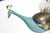Unique, large bronze peacock has a brass brush tail with colorful glass jewels, aqua blue painted body, perched on a large...