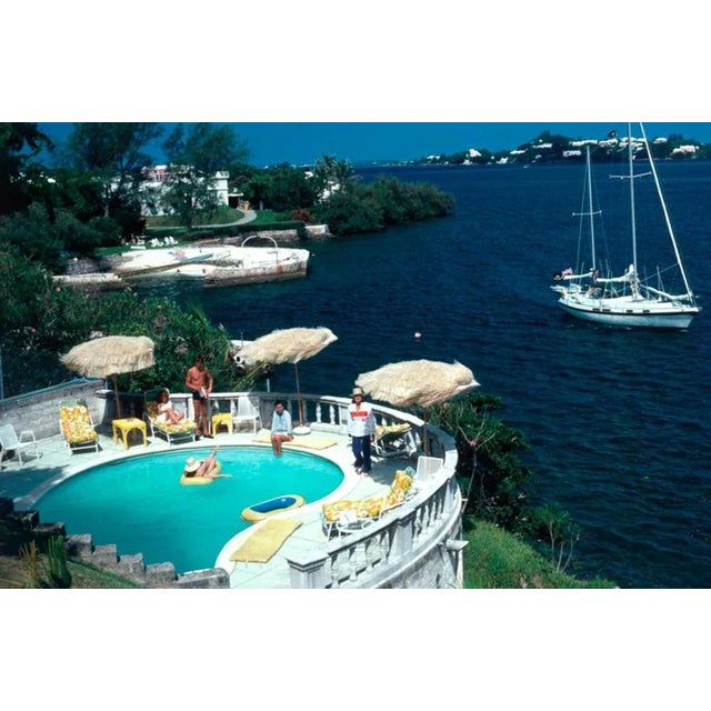 Bermuda Idyll 1977 by Slim Aarons Slim Aarons Limited Estate Edition Mrs Frank McMahon and guests around the pool at her...