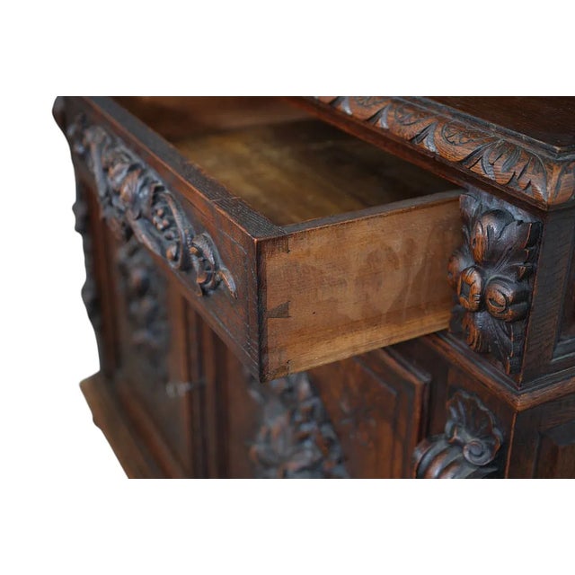 This product is a large French antique heavily carved oak hunt board with a raised panel door style. It features intricate...