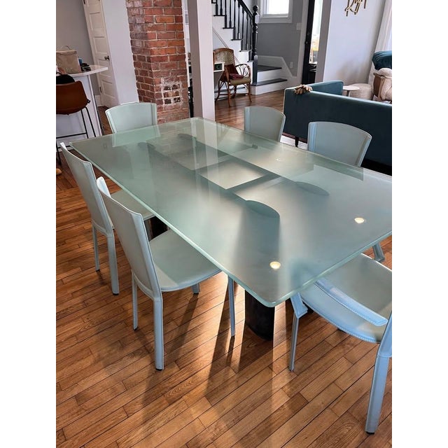Custom modern dining room set consisting of 3/4 inch thick glass table rests on top of a simple, yet elegant, black steel...
