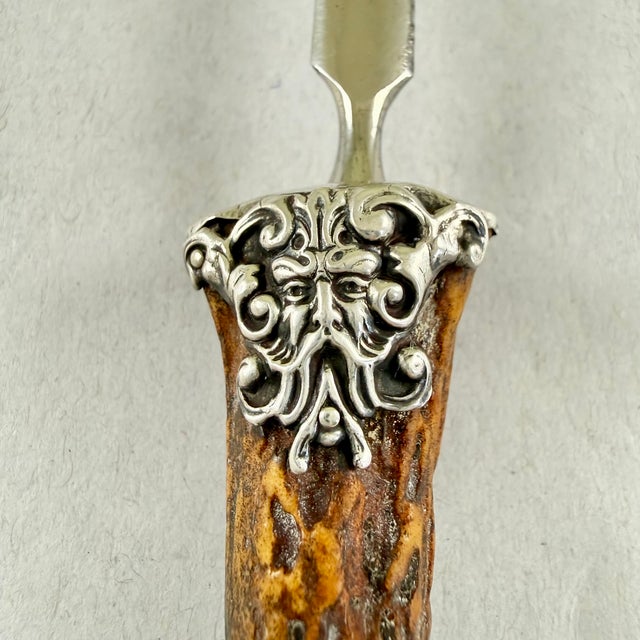 A letter knife or opener made of naturally shed Stag Horn with a Sterling Silver ferrule, England, circa 1890-1910. The...