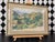 Original colored pencil landscape drawing depicting rolling golden hills, a lush green valley, and layered trees beneath a...