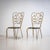 Pair of Italian side chairs crafted from bent tubular metal with a gilt-patinated finish. The chairs are distinguished by...