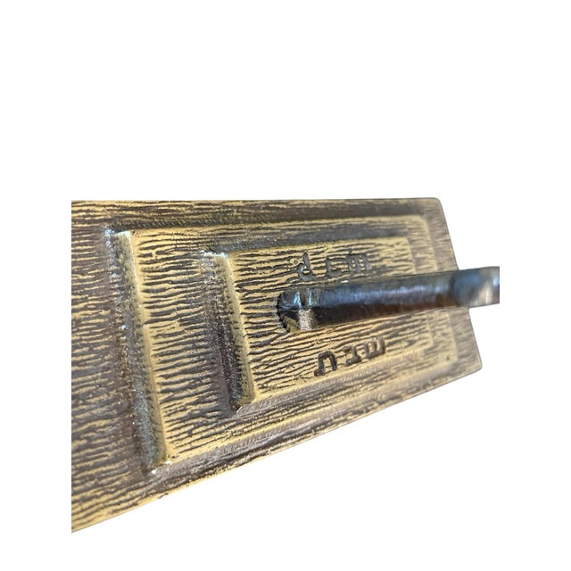 This is a vintage brass Jewish menorah candle holder designed in a mid-century modern style. It features seven candle...