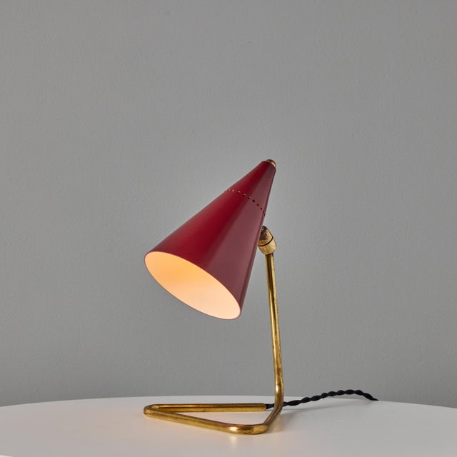 1950s Giuseppe Ostuni Red Conical Table Lamp for Oluce A sculptural design executed in enameled red metal and brass. Shade...