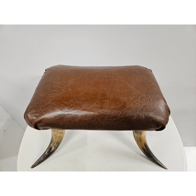 This antique leather and horn footstool is sure to bring some vintage southwest charm to any home. The stool is in good...