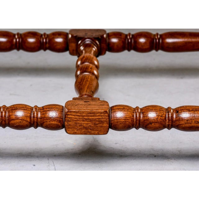 Circa 1850s French mahogany console with rectangular link design in relief on apron and sides. Turned legs and stretchers....