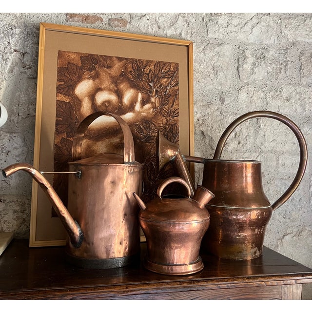 Large 19th century French copper pitcher. The can is 22 Inches across from spout to handle, is hand crafted and includes a...