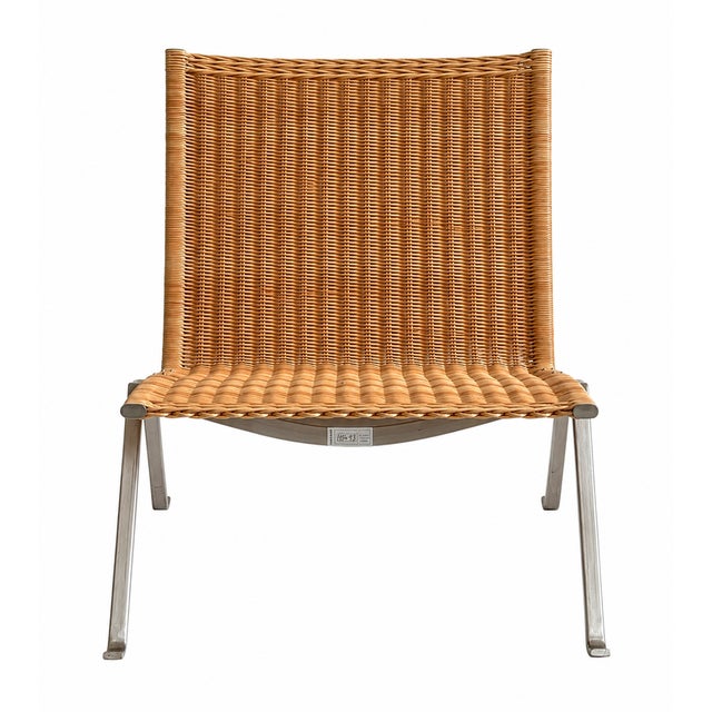 Replica PK22 lounge chair. Features a woven wicker seat and back with a steel frame. Dimensions: 24.8" W x 24.8" D x 26.8" H