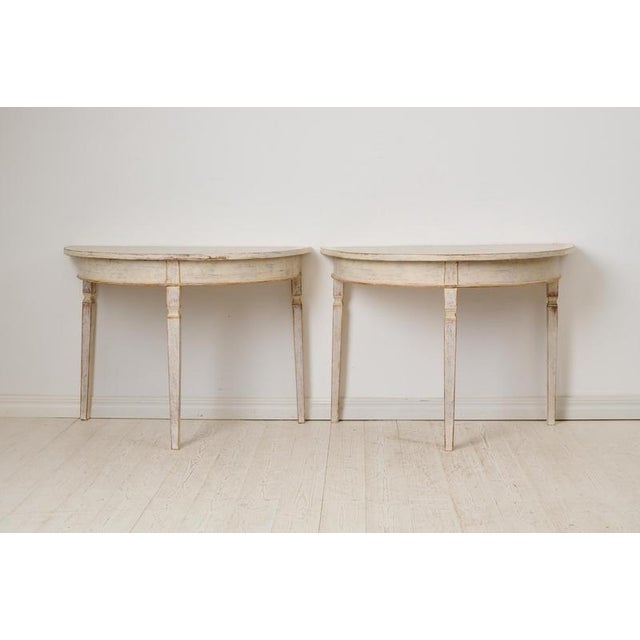 Antique genuine demi-lune table in neoclassical style from northern Sweden. The table is round and consists of two free-...