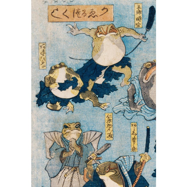 Japanese woodblock art print reproduction by Utagawa Kuniyoshi featuring whimsical frogs dressed as Kabuki actors,...
