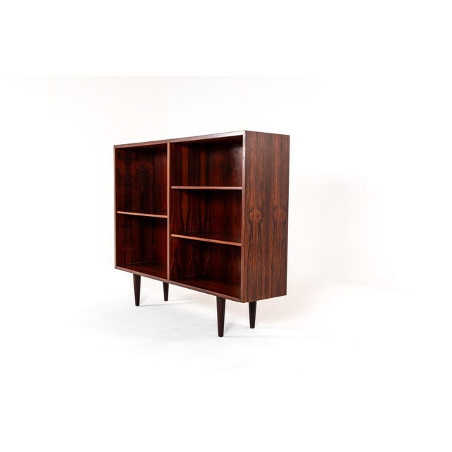 Elegant Danish mid-century bookcase designed and manufactured by Omann Jun, Model 9. Crafted from richly grained rosewood,...