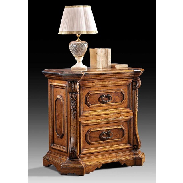 Handcrafted in Italy from solid walnut. The nightstand features beautifully hand-carved corbels and framed walnut burl...