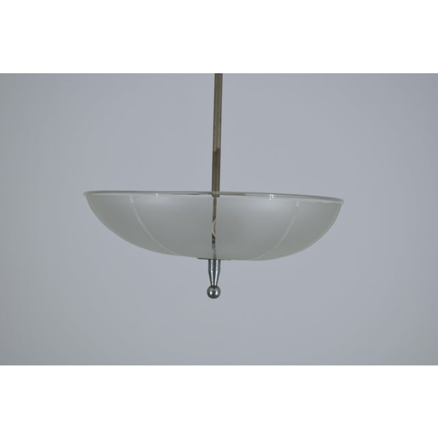 A charming 1940s Italian chandelier featuring an elegant satin-finish glass disc diffuser, embellished with subtle radial...
