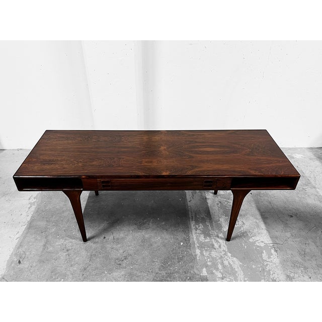 A rare hardwood coffee table attributed renowned danish designers nanna & jørgen ditzel. • features two drawers and two...