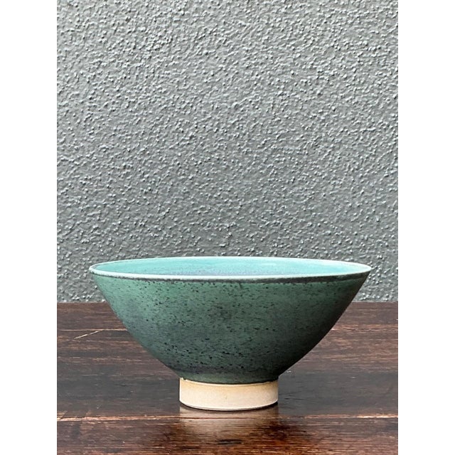This vintage handcrafted ceramic bowl exemplifies the understated beauty of studio pottery through its elegant form and...